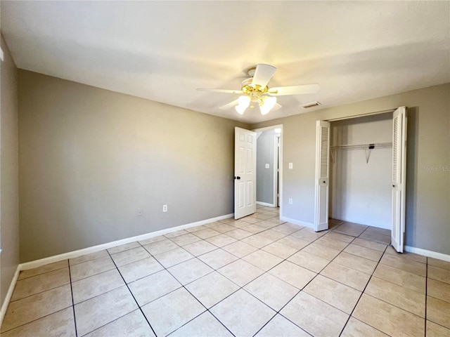 unfurnished bedroom featuring a closet, ceiling fan, and light tile floors