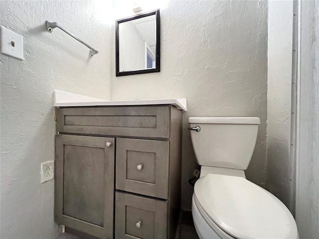 bathroom featuring oversized vanity and toilet