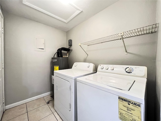 laundry area featuring washing machine and dryer, light tile floors, and electric water heater