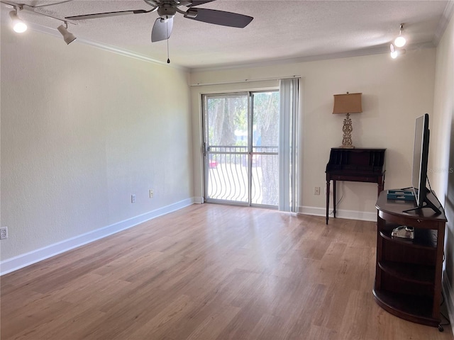 living room with hardwood / wood-style flooring, ceiling fan, and a textured ceiling