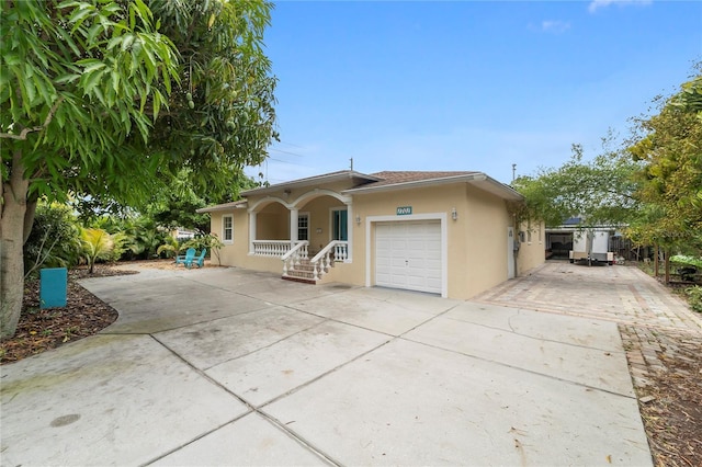 view of front of home featuring a porch and a garage