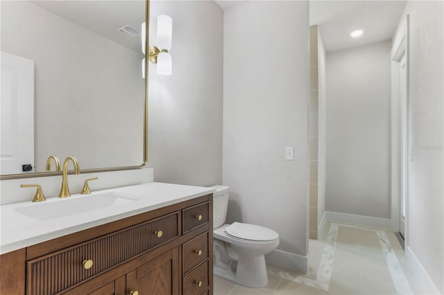 bathroom with tile patterned floors, vanity, and toilet