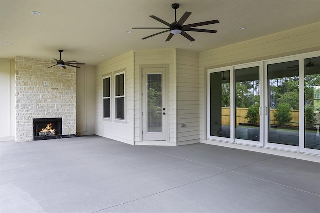 view of patio featuring ceiling fan and an outdoor brick fireplace