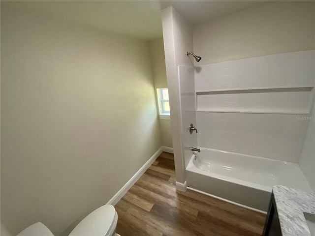 full bathroom featuring toilet, shower / bath combination, hardwood / wood-style floors, and vanity