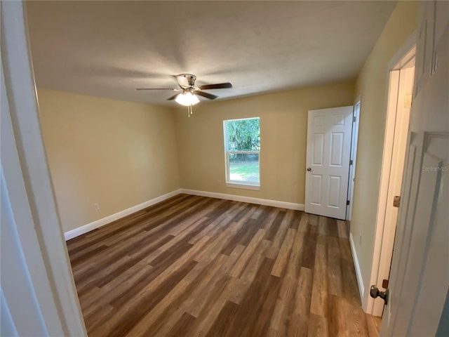 spare room with wood-type flooring and ceiling fan