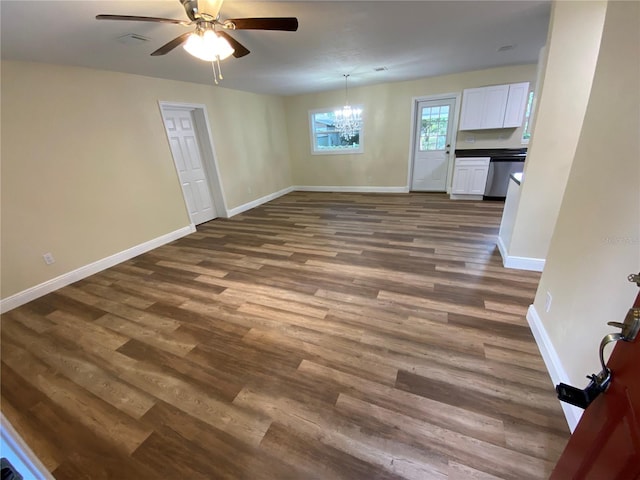 unfurnished living room with wood-type flooring and ceiling fan with notable chandelier