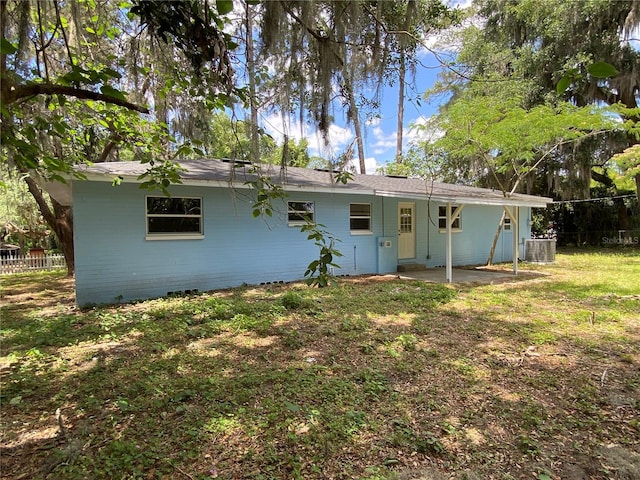 back of property with a patio and a yard