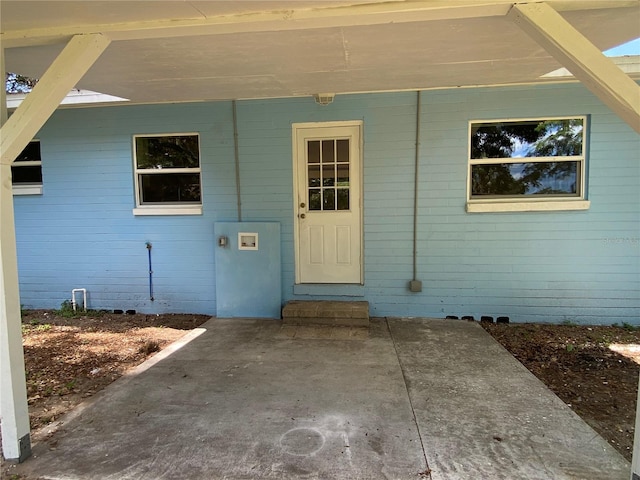 view of exterior entry featuring a patio