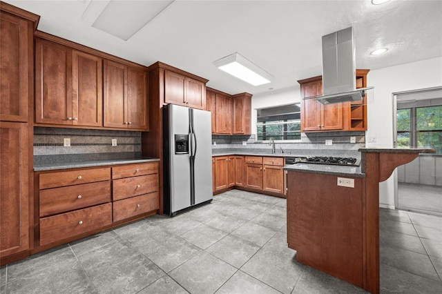 kitchen with light tile floors, island exhaust hood, and stainless steel appliances