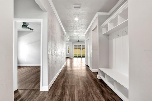 hallway with ornamental molding and dark hardwood / wood-style flooring