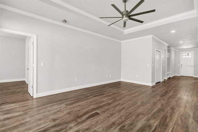 empty room featuring dark wood-type flooring, ceiling fan, and crown molding