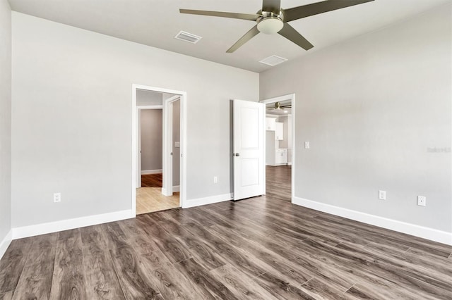 unfurnished bedroom with ceiling fan and dark hardwood / wood-style flooring