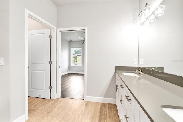 bathroom featuring dual vanity and hardwood / wood-style flooring