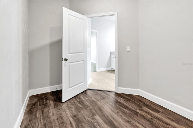 unfurnished bedroom featuring dark hardwood / wood-style flooring