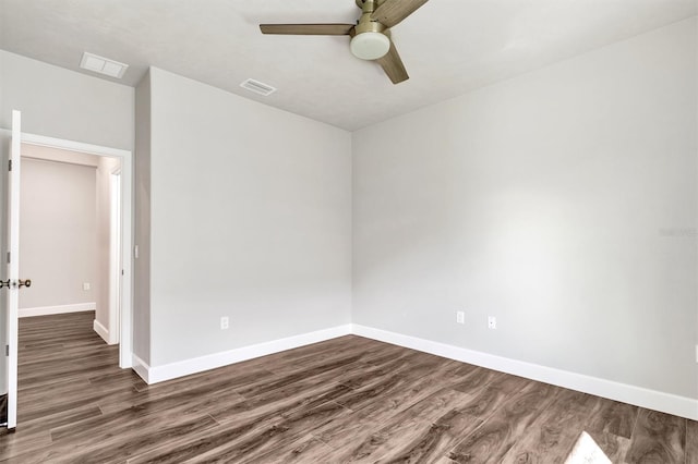 empty room with dark hardwood / wood-style floors and ceiling fan