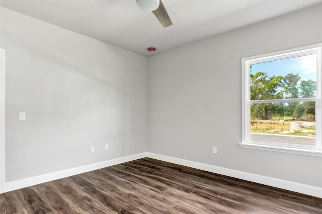 spare room with ceiling fan and dark hardwood / wood-style flooring