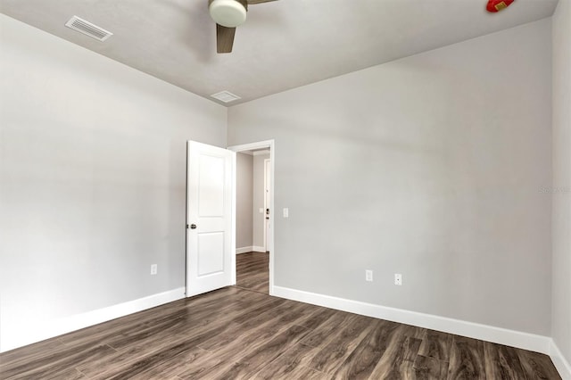 spare room featuring ceiling fan and dark hardwood / wood-style flooring