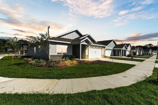 view of front of property with a garage and a lawn