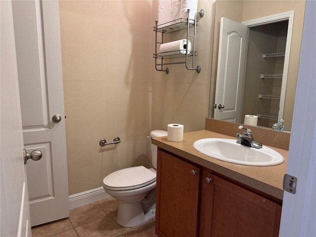 bathroom featuring toilet, vanity, and tile patterned flooring