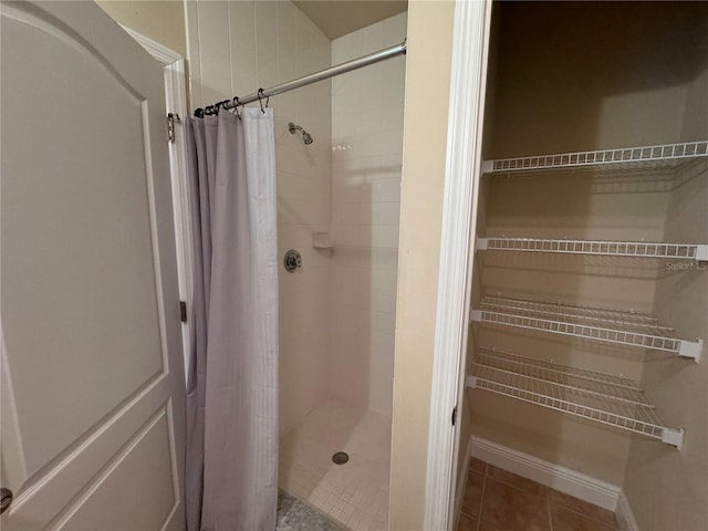 bathroom featuring tile patterned floors and a shower with curtain