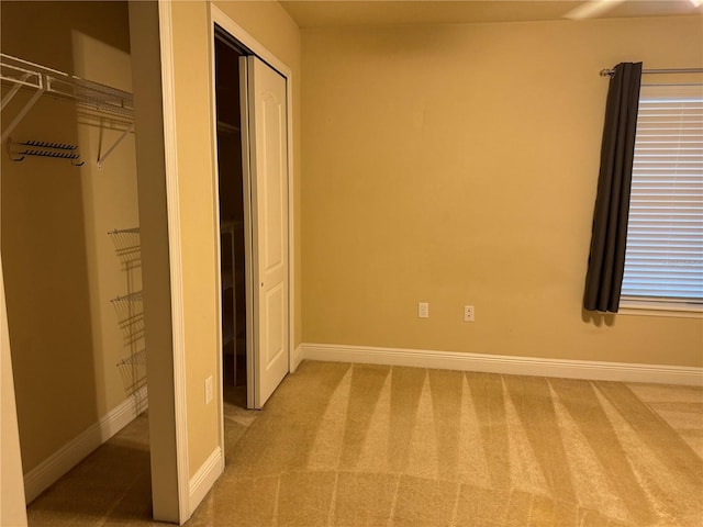 unfurnished bedroom with carpet and a closet