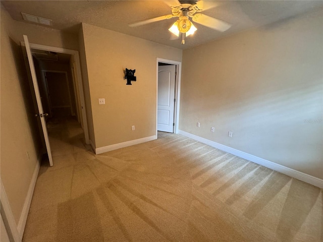 unfurnished bedroom with ceiling fan, a closet, and light colored carpet