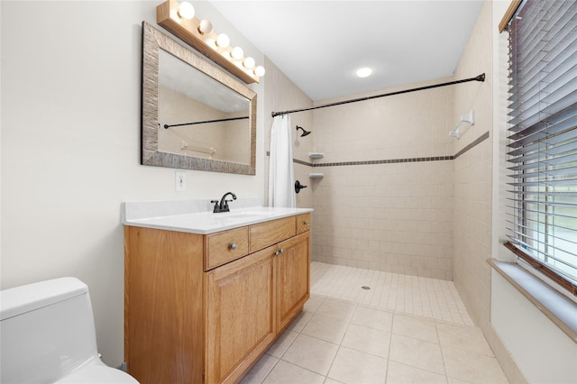 bathroom with vanity, toilet, tile patterned floors, and walk in shower