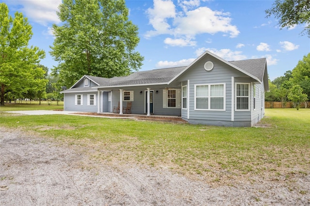 ranch-style home featuring a front yard and a porch