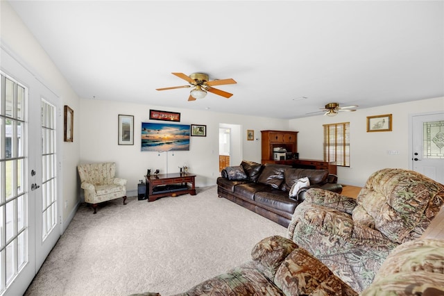 living room with ceiling fan, light colored carpet, and french doors