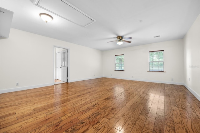 empty room with light wood-type flooring and ceiling fan