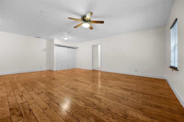 unfurnished bedroom with ceiling fan, a closet, and hardwood / wood-style flooring