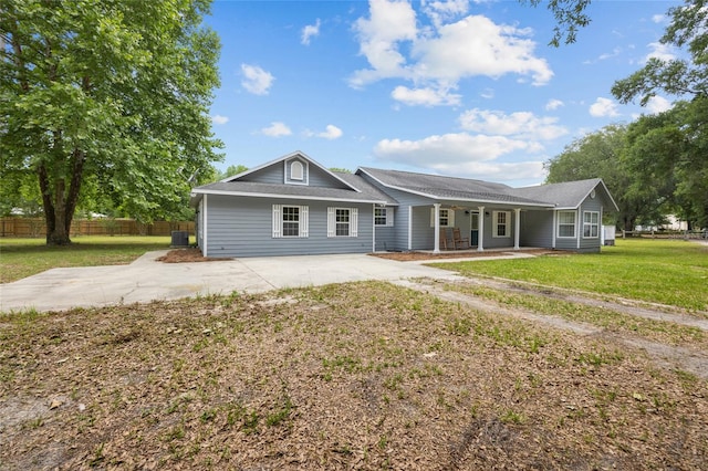 ranch-style home with a front lawn and central air condition unit