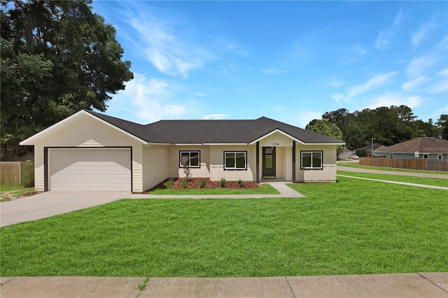 ranch-style house featuring a front lawn and a garage