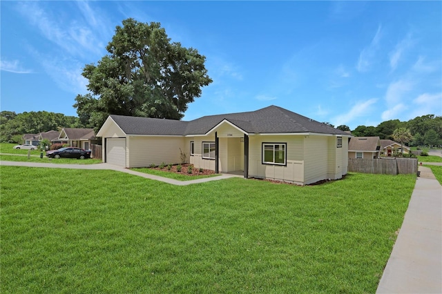 ranch-style house with a garage and a front lawn