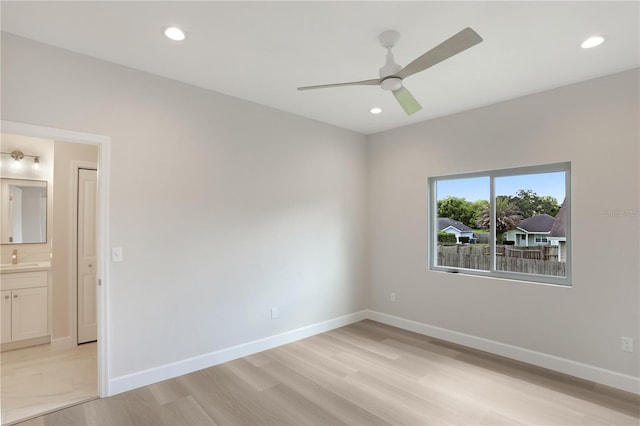 spare room featuring sink, light wood-type flooring, and ceiling fan