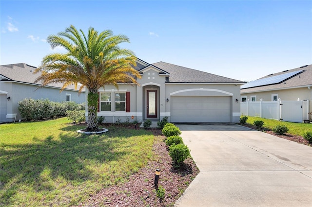 ranch-style home with a garage, a front lawn, and solar panels