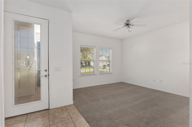 tiled entryway with ceiling fan