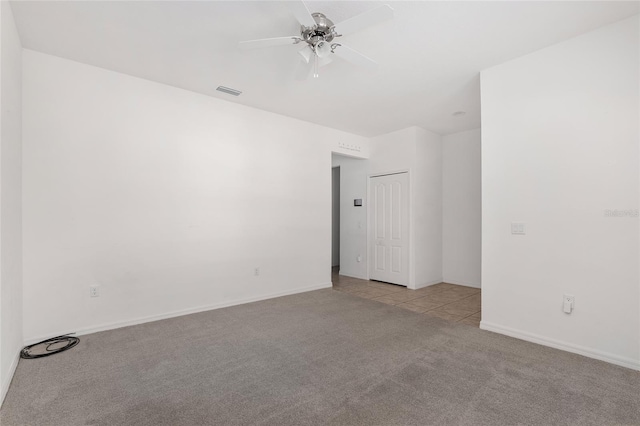 carpeted empty room with ceiling fan