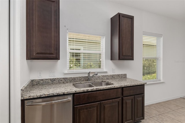 kitchen featuring dark brown cabinets, sink, dishwasher, and light tile floors