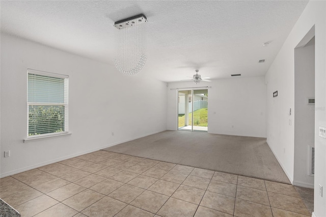 tiled spare room featuring ceiling fan and a textured ceiling