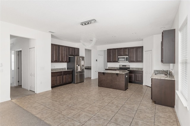 kitchen featuring a kitchen island, stainless steel appliances, light carpet, dark brown cabinets, and sink