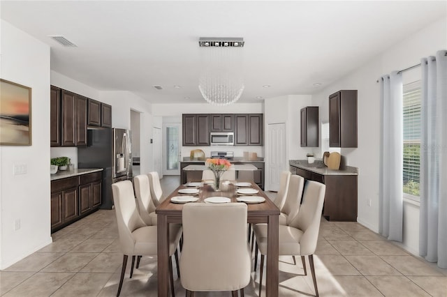 dining area with a notable chandelier and light tile flooring