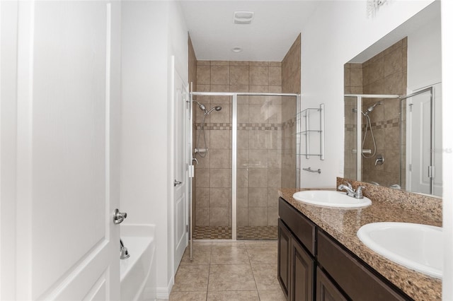 bathroom featuring tile floors, double sink vanity, and plus walk in shower