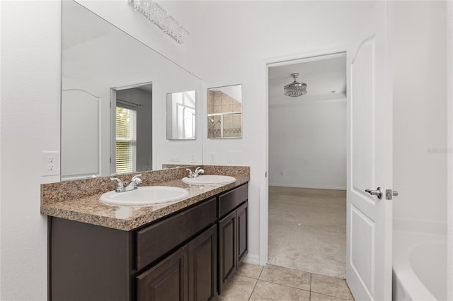 bathroom featuring tile flooring, a washtub, dual sinks, and large vanity