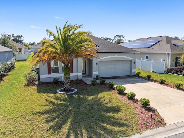 view of front of property with a garage, a front lawn, and solar panels