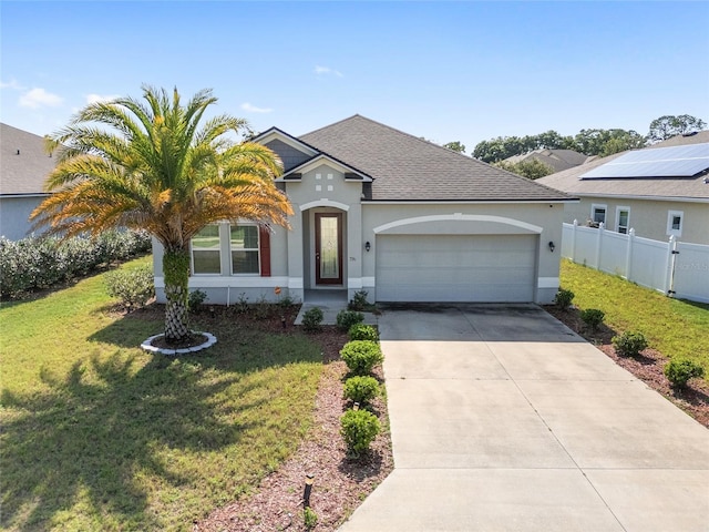 view of front of home featuring a garage, solar panels, and a front lawn