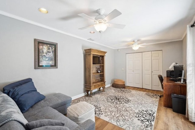 office space with ceiling fan, light wood-type flooring, and crown molding