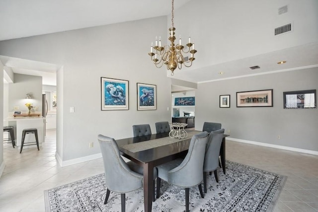 dining room featuring light tile patterned floors, high vaulted ceiling, and an inviting chandelier