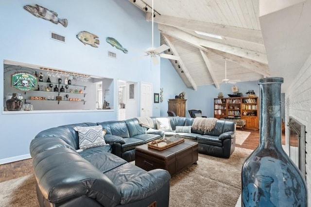 living room featuring ceiling fan, beam ceiling, wood ceiling, and high vaulted ceiling