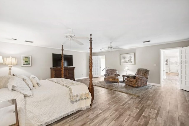 bedroom with ceiling fan, wood-type flooring, and ornamental molding